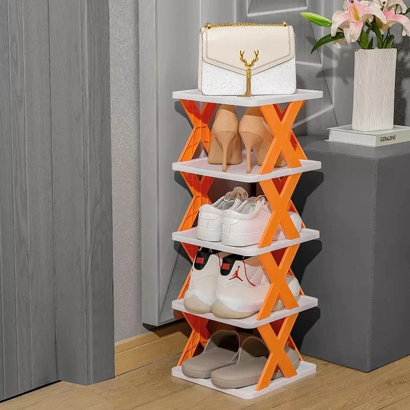 Multi-layer vertical shoe organizer in random color placed in a minimalist entryway.